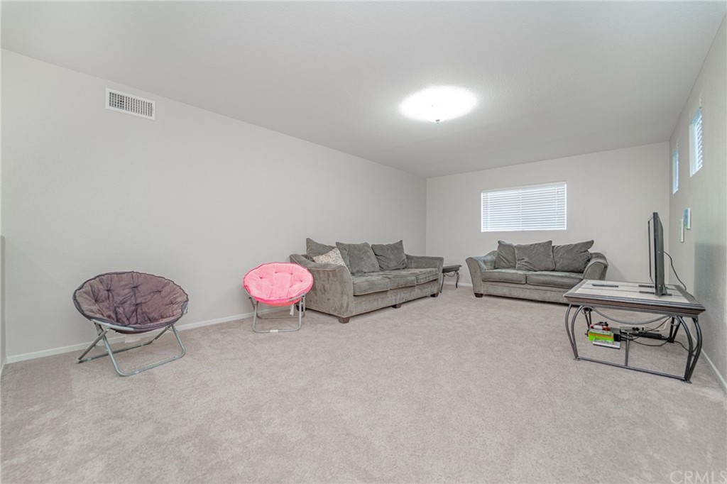 2810 Athens Circle Corona, CA 92882 - Photo 30 of 34 a living room with furniture and a table