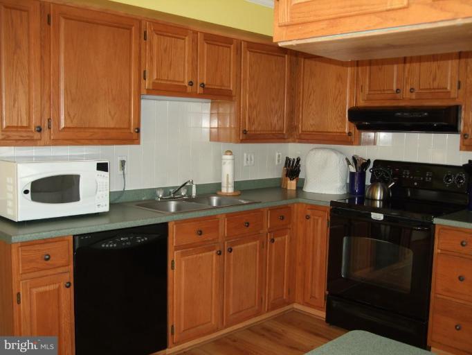 111 Cross Ridge Court Stafford, VA 22554 - Photo 4 of 23 a kitchen with granite countertop wooden cabinets and a sink
