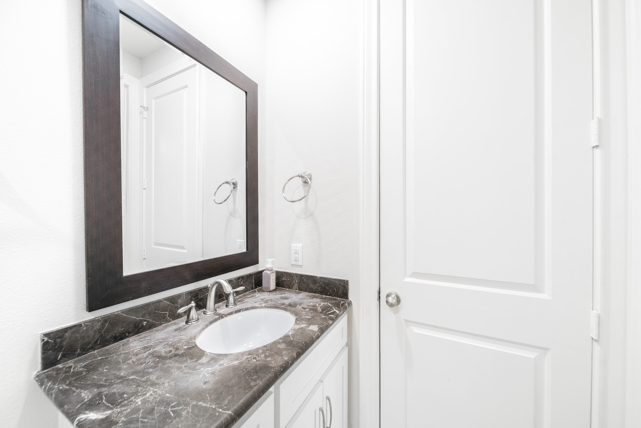 2426 Bevis Street Houston, TX 77008 - Photo 12 of 25 a bathroom with a granite countertop sink and a mirror