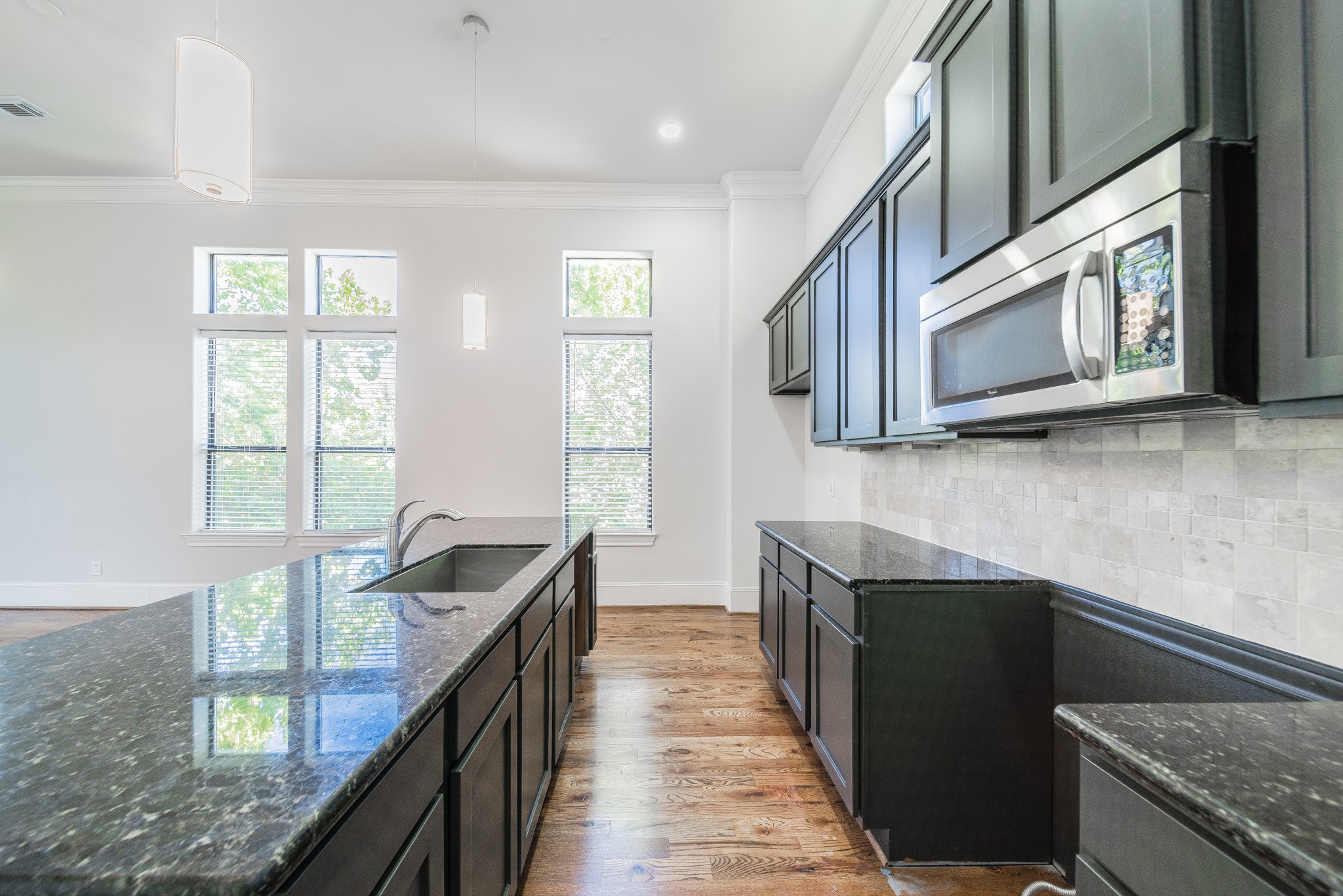 2426 Bevis Street Houston, TX 77008 - Photo 15 of 25 a kitchen with stainless steel appliances granite countertop a sink stove and microwave