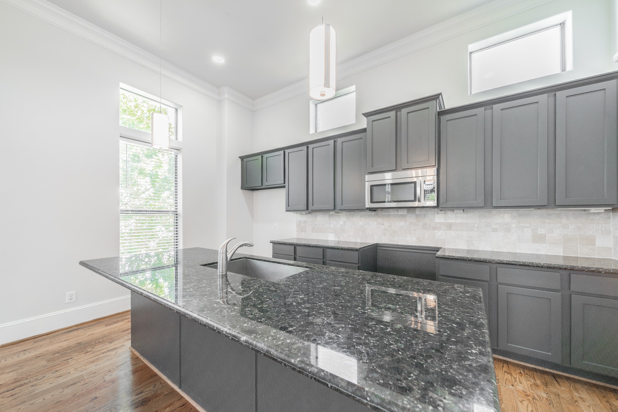 2426 Bevis Street Houston, TX 77008 - Photo 16 of 25 a kitchen with stainless steel appliances granite countertop a sink a microwave and wooden cabinets
