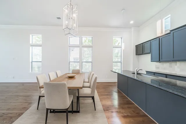 a view of a dining room with furniture a chandelier and wooden floor
