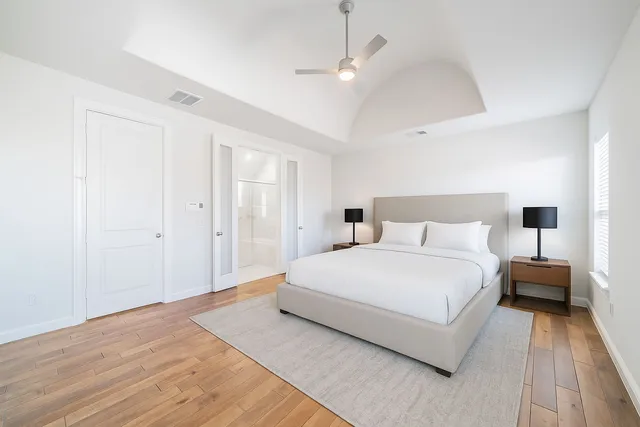 a bedroom with a bed and a night stand