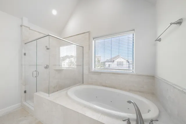a bathroom with a bathtub and a shower