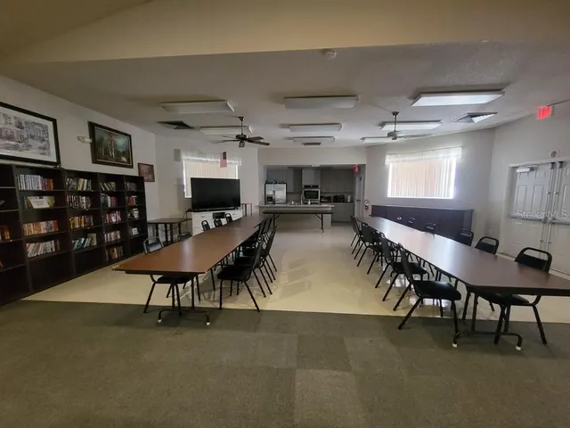 a living room with furniture a rug and a chandelier