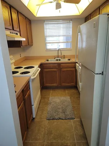 a kitchen with a refrigerator and a sink