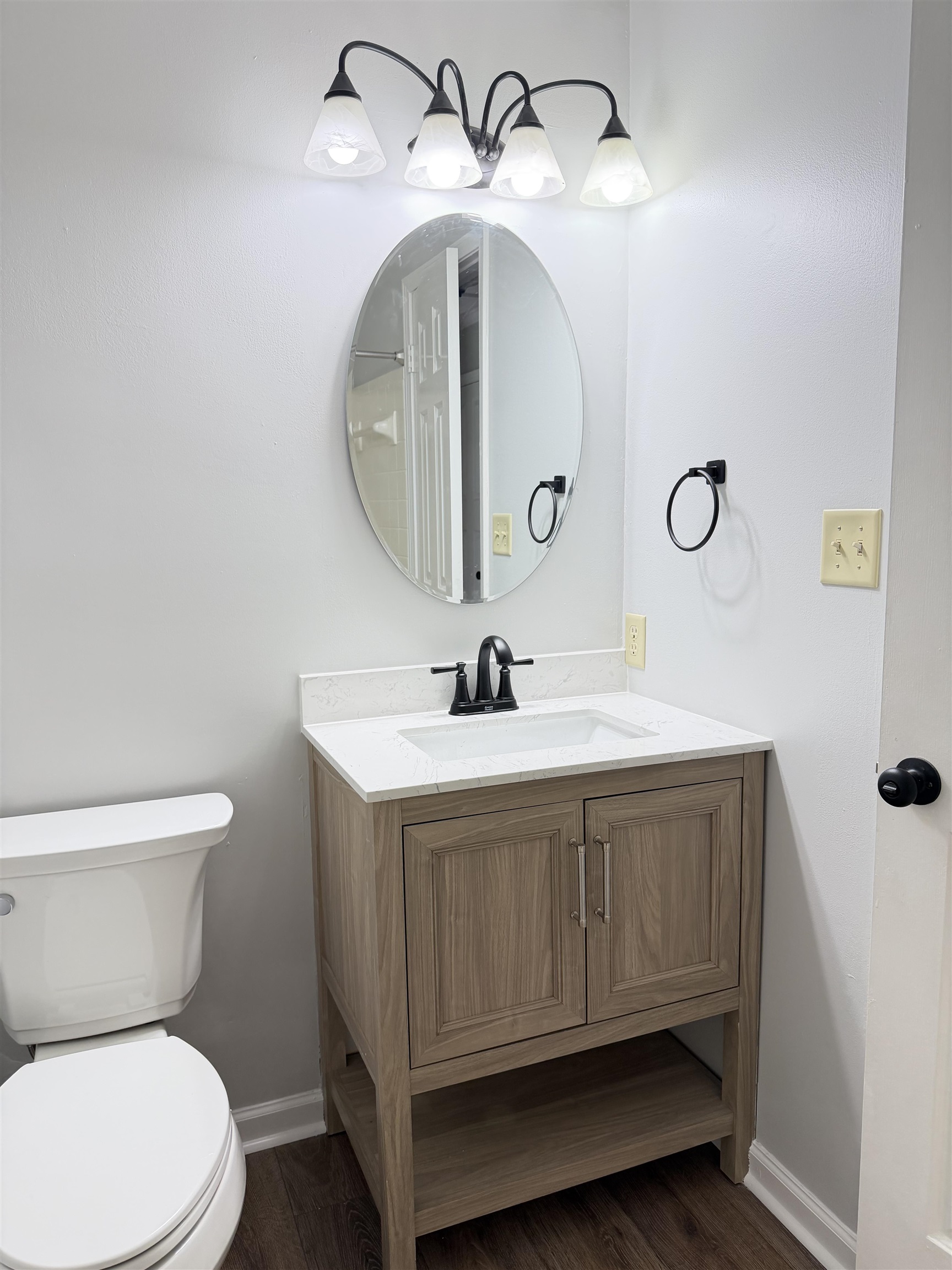 388 Park Hill Road Collierville, TN 38017 - Photo 19 of 19 Bathroom featuring a wood-finish vanity with a white countertop, an undermount sink, and matte black hardware