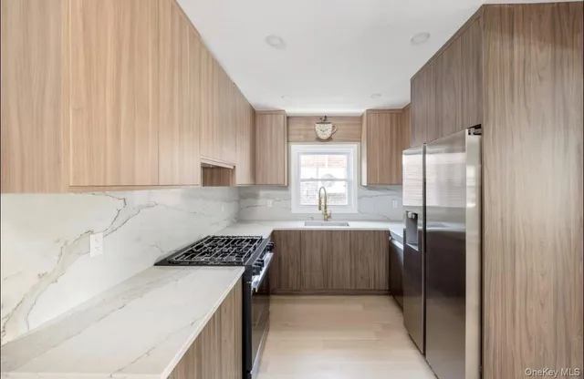 a kitchen with a sink stove and refrigerator