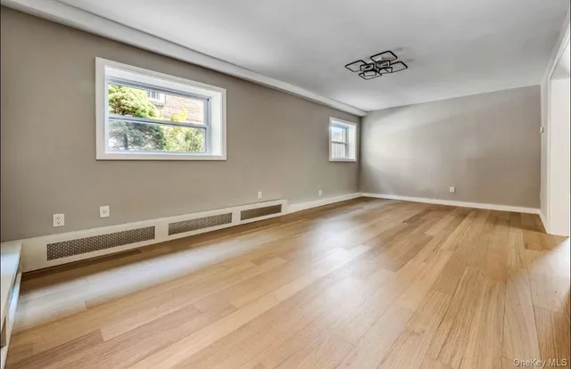 a view of a room with wooden floor and window
