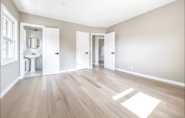 a view of a room with wooden floor and white walls