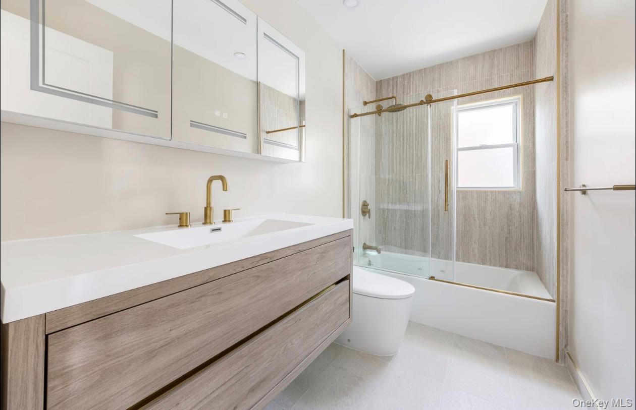 208-12 53rd Avenue Queens, NY 11364 - Photo 10 of 11 a bathroom with a double vanity sink toilet and shower