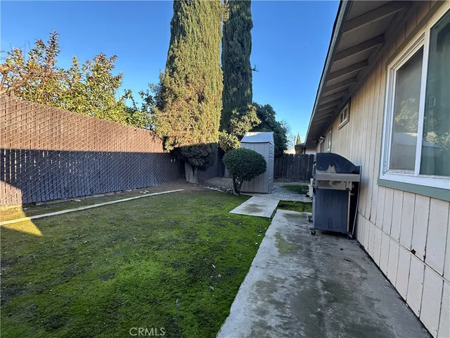 a view of backyard with wooden fence
