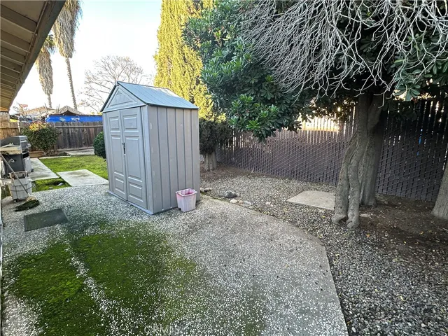 a view of a pathway gate with wooden fence