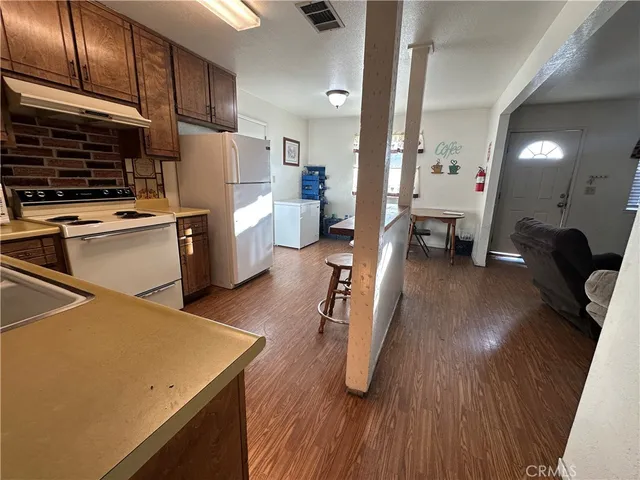 a kitchen with sink cabinets and wooden floor