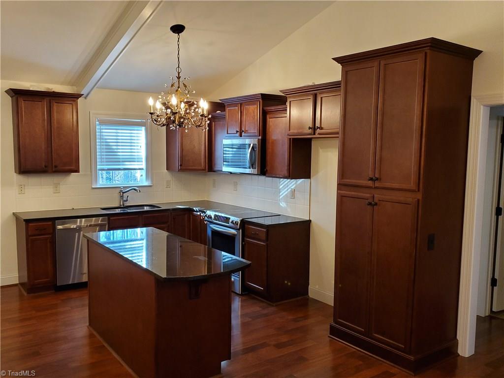 160 Campsite Road Stokesdale, NC 27357 - Photo 3 of 9 Kitchen with Granite Tops and Tile Backsplash