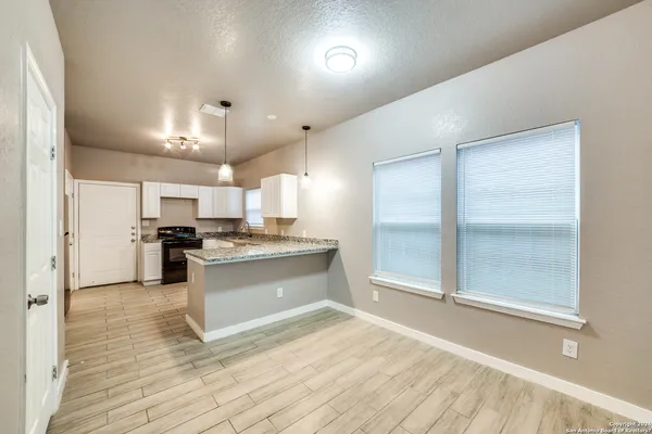 a large kitchen with kitchen island a sink stainless steel appliances and cabinets