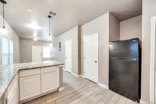 a kitchen with stainless steel appliances granite countertop a refrigerator a sink and a refrigerator