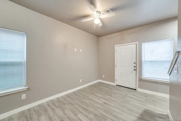 wooden floor in an empty room with a window