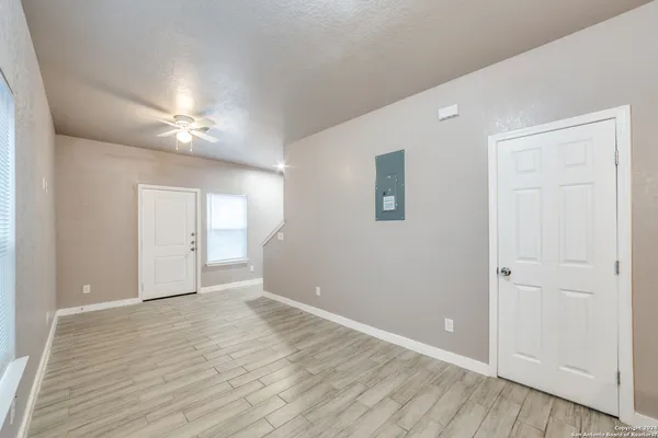 a view of an empty room with wooden floor