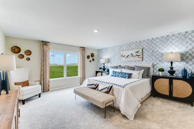 a spacious bedroom with a bed couch and a large window