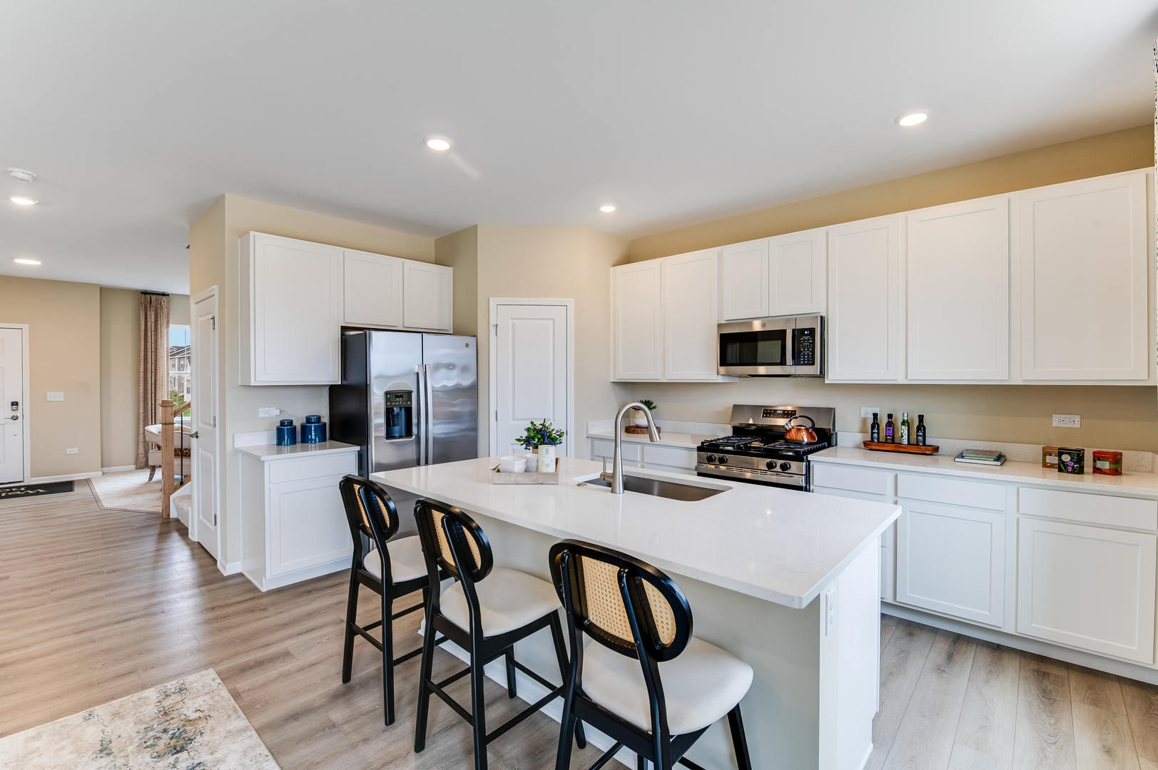 611 Lismore Circle Elgin, IL 60124 - Photo 7 of 24 a kitchen with stainless steel appliances a table and chairs in it