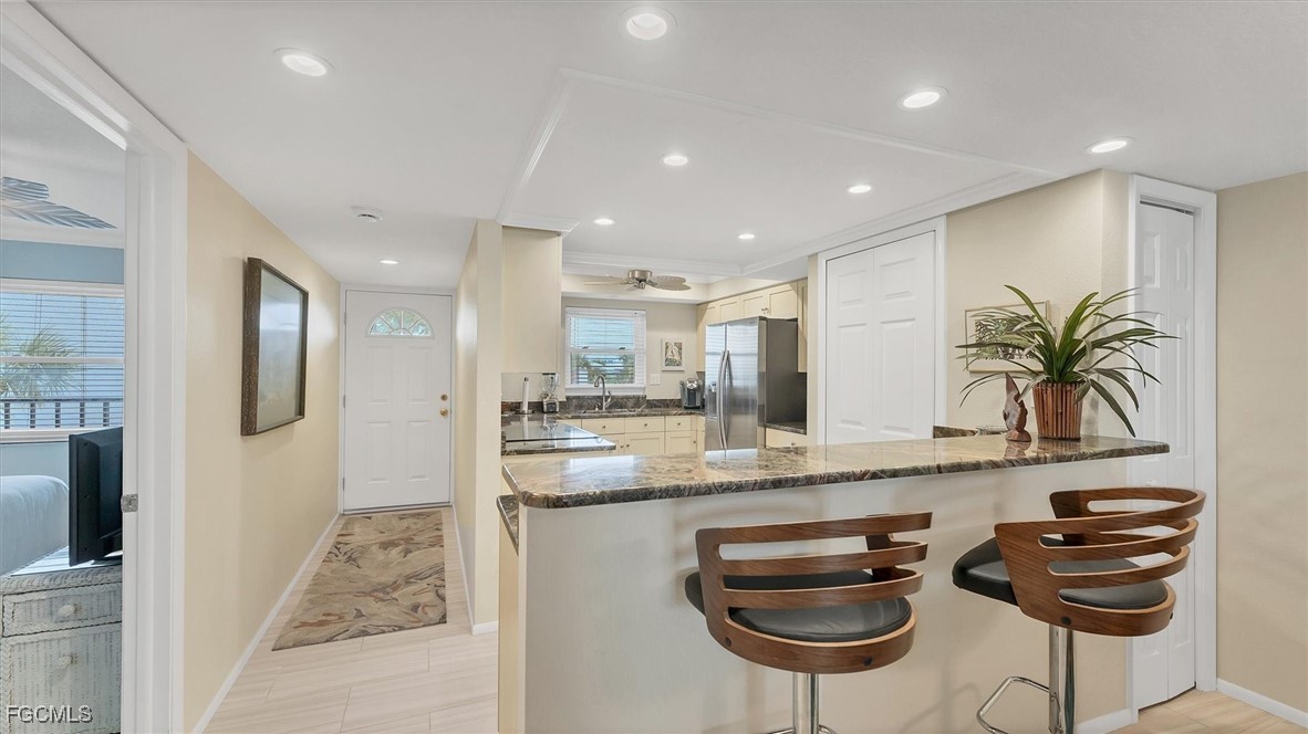 2700 North Beach Road, Unit B205 Englewood, FL 34223 - Photo 15 of 47 a kitchen with stainless steel appliances granite countertop a sink and a refrigerator