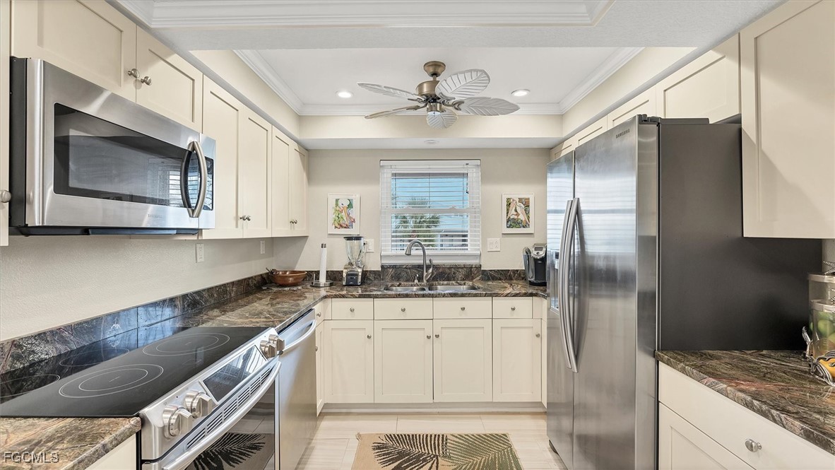 2700 North Beach Road, Unit B205 Englewood, FL 34223 - Photo 16 of 47 a kitchen with granite countertop a sink stainless steel appliances and cabinets