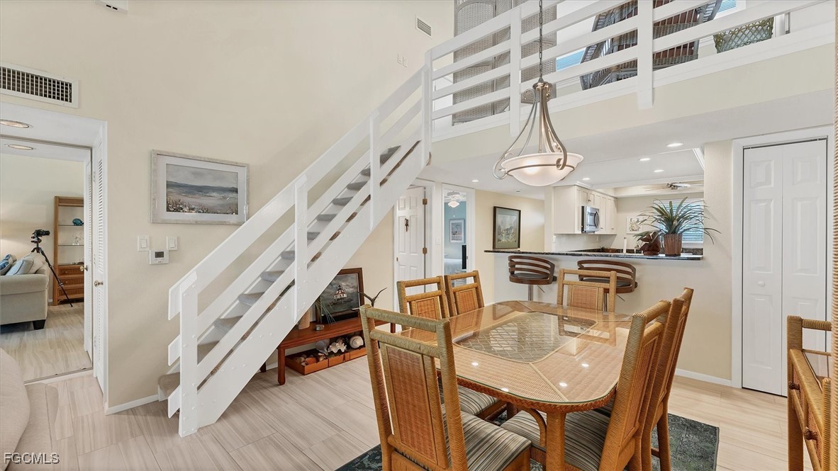 2700 North Beach Road, Unit B205 Englewood, FL 34223 - Photo 21 of 47 a dining room with furniture entryway and wooden floor