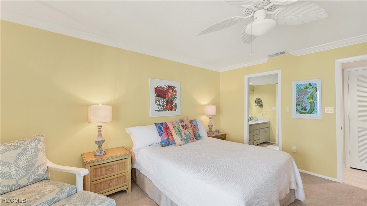 2700 North Beach Road, Unit B205 Englewood, FL 34223 - Photo 25 of 47 a bedroom with a bed and a chandelier
