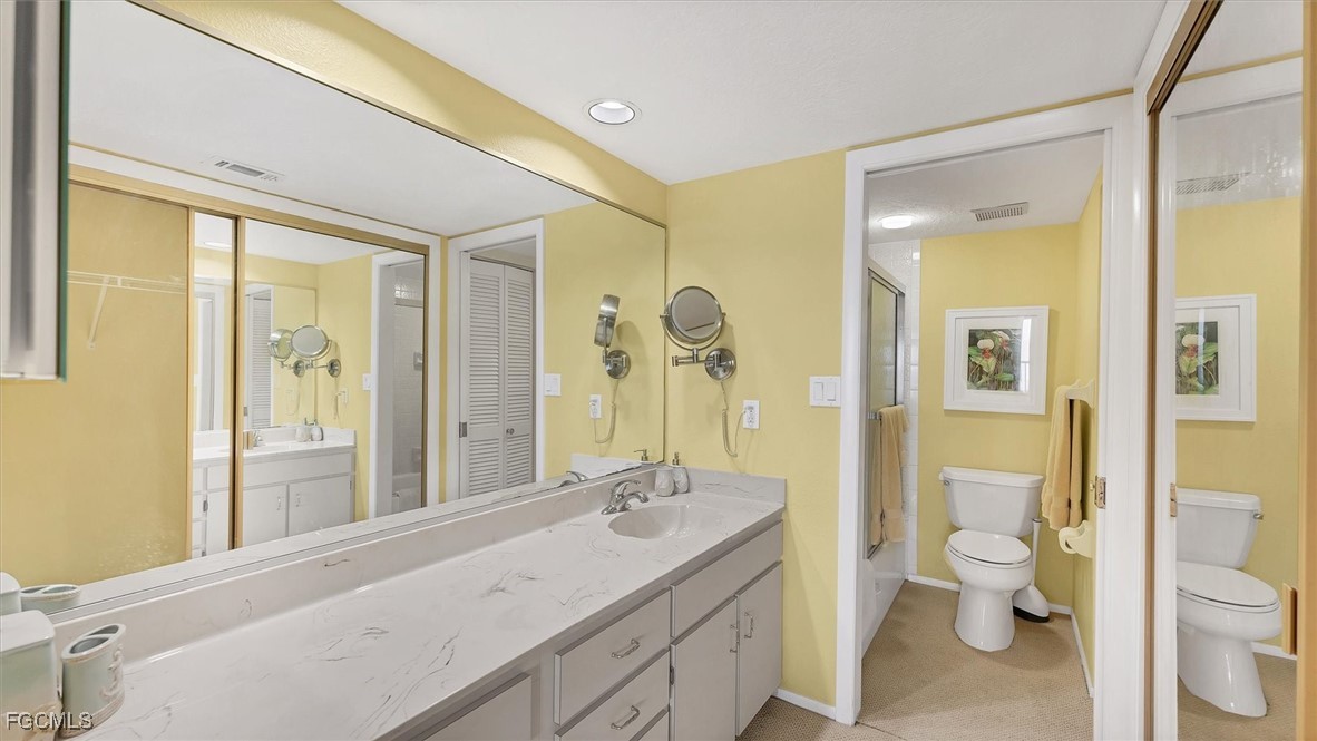 2700 North Beach Road, Unit B205 Englewood, FL 34223 - Photo 26 of 47 a bathroom with a granite countertop sink toilet and shower