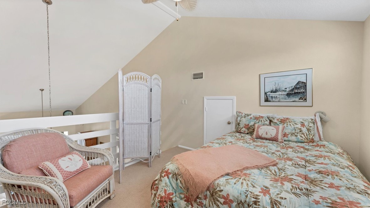 2700 North Beach Road, Unit B205 Englewood, FL 34223 - Photo 32 of 47 a bedroom with a bed and a dresser