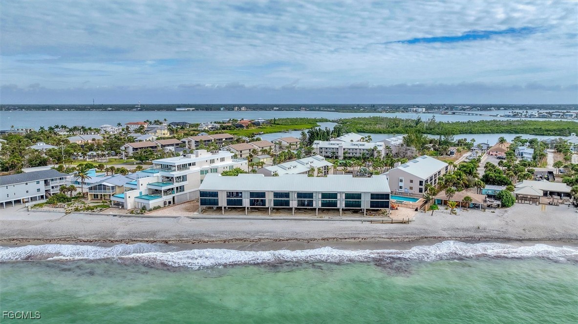 2700 North Beach Road, Unit B205 Englewood, FL 34223 - Photo 42 of 47 a view of a big yard with table and chairs