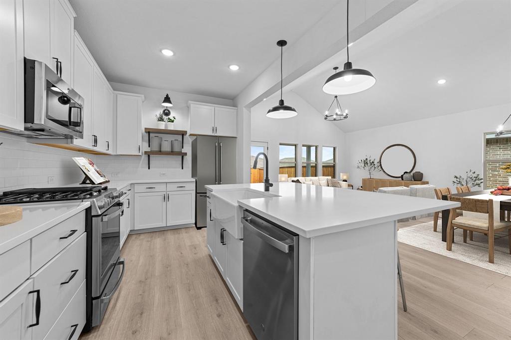 1509 Hamilton Street Howe, TX 75459 - Photo 8 of 23 Kitchen featuring light countertops, stainless steel appliances, open shelves, and a sink