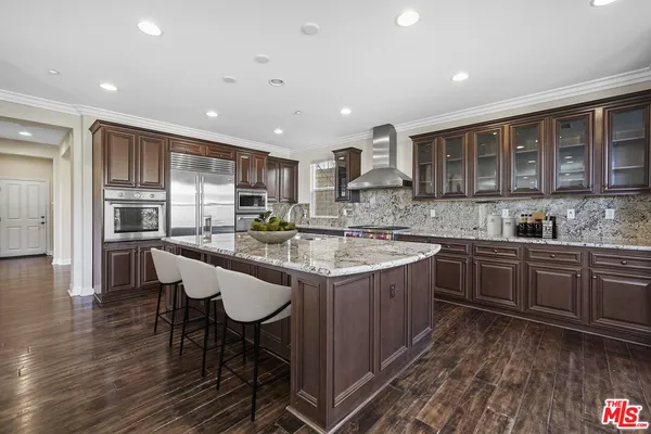 a kitchen with a sink cabinets and wooden floor