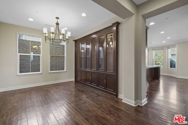a view of a room with wooden floor and windows