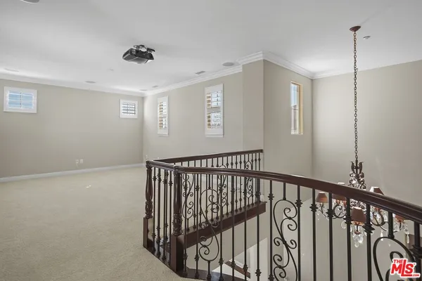 a view of staircase with railing and a rug
