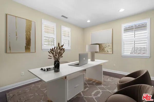a bedroom with a bed a couch and potted plant