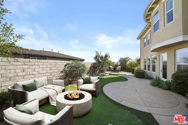 a view of a garden with a house