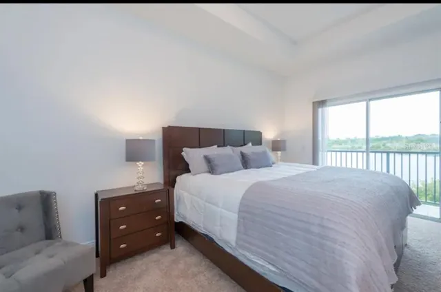 a bedroom with a bed and a large window