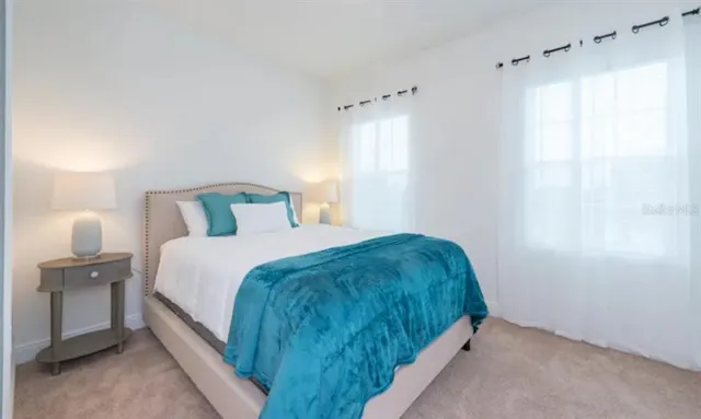 a bedroom with a bed and a window