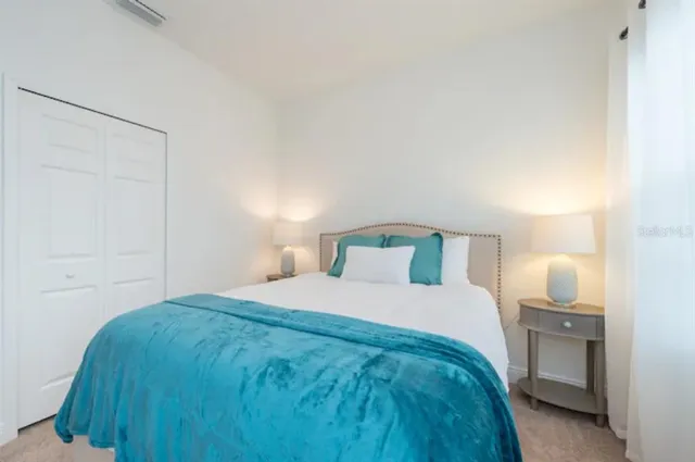 a bedroom with a bed and a night stand