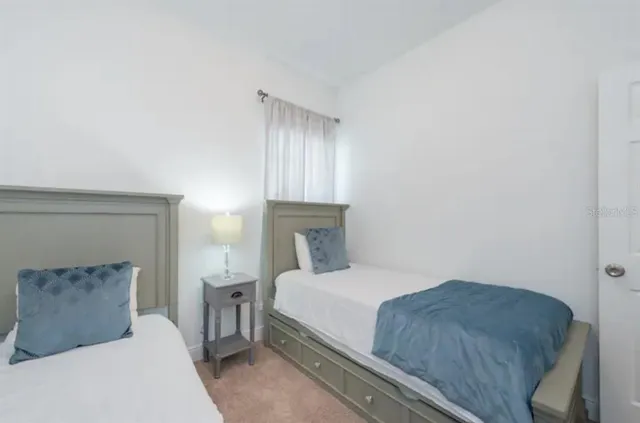 a bedroom with a bed and a lamp