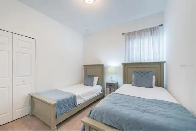 a bedroom with a bed and a night stand