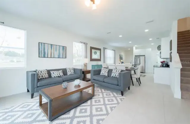 a living room with furniture and a window