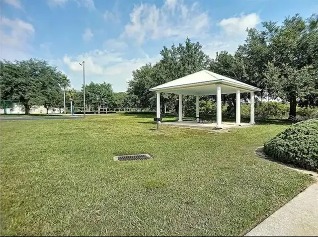 a backyard of a house with table and chairs