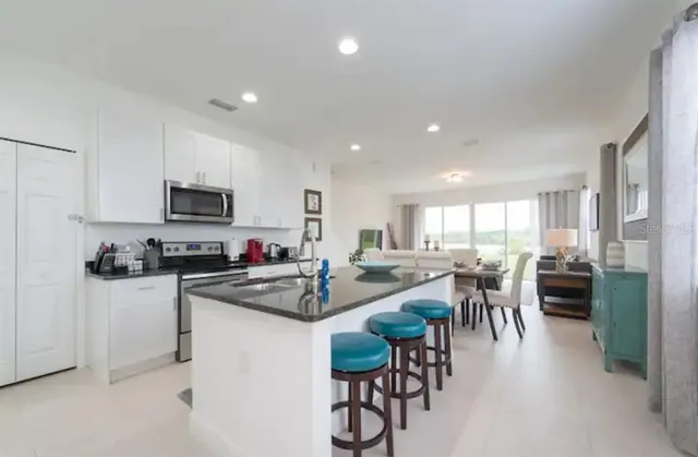 a kitchen with a table and chairs