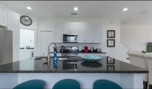 a kitchen with cabinets and window