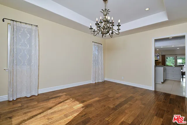a kitchen with granite countertop a sink stove and cabinets