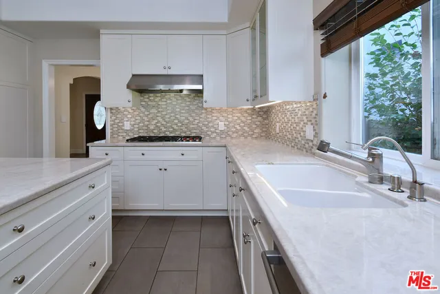 a kitchen with a table and chairs in it