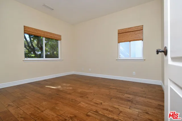 an empty room with windows and closet